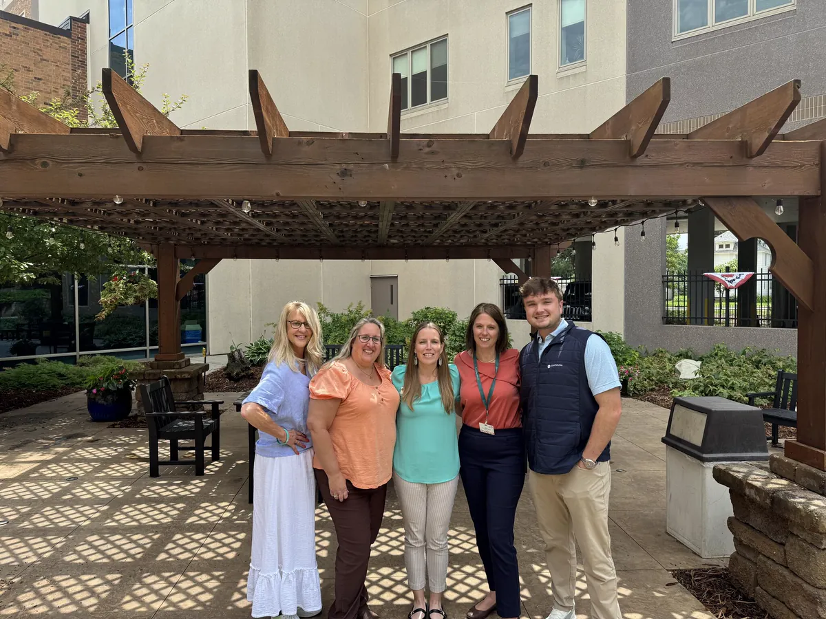 Continuum team members with facility partners in a courtyard
