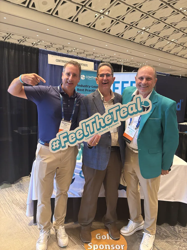 Continuum leaders striking a pose with the #FeelTheTeal sign
