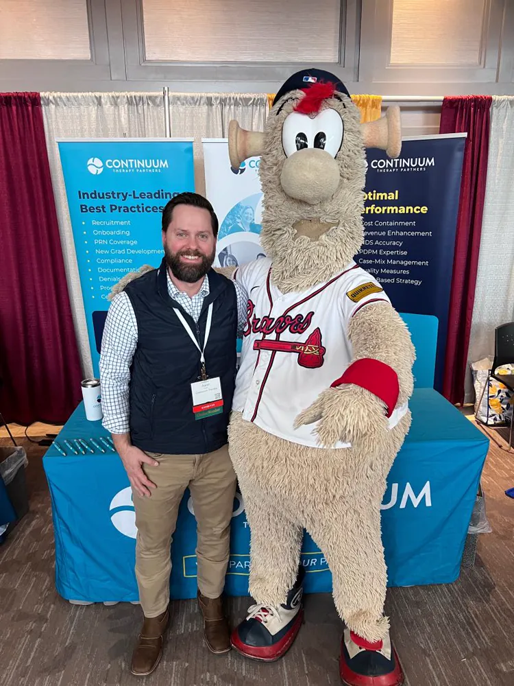 A Continuum team member with the Atlanta Braves mascot at the Continuum booth