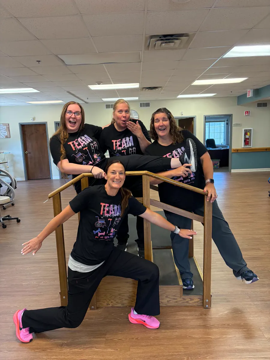 Continuum therapists in matching team shirts in a therapy gym
